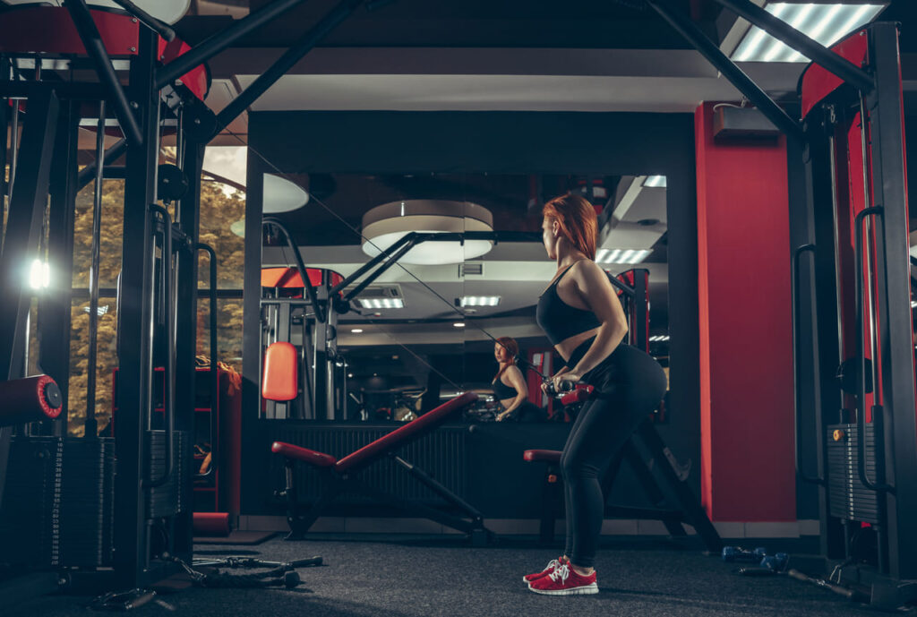 young-muscular-caucasian-woman-practicing-in-gym-with-equipment-wellness-healthy-lifestyle-bodybuilding